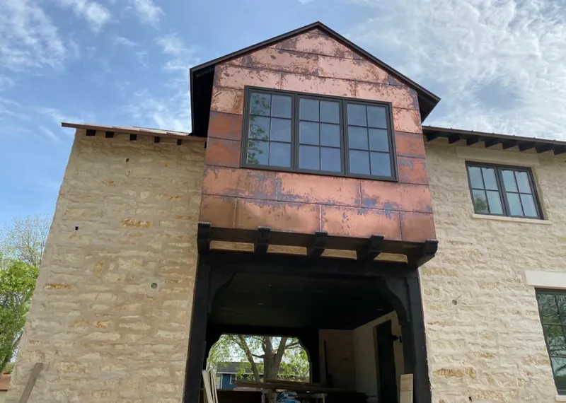 Copper metal panel facade on a stone building for Skylight Installation in Herriman