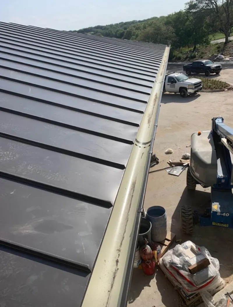 Standing seam panel and gutter detail on a metal roofing jobsite in Herriman